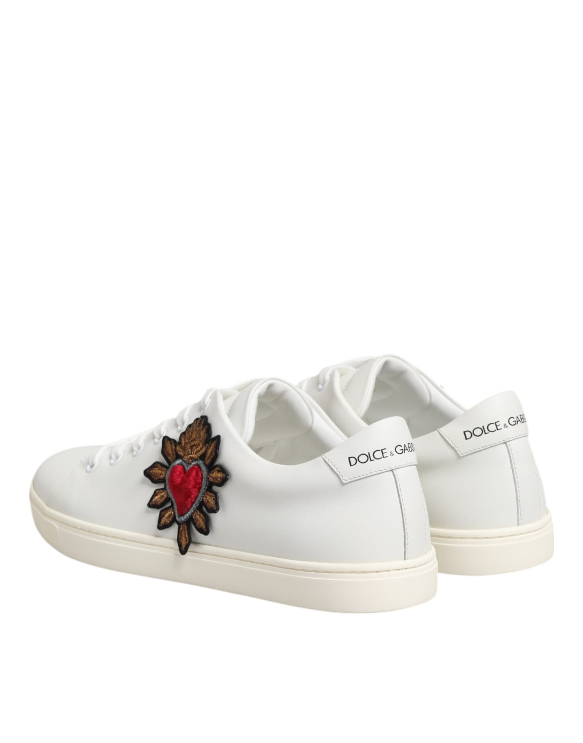 White leather sneakers with a heart patch on the side, featuring the brand name