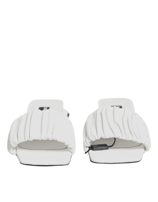Pair of white slippers with fringe detailing