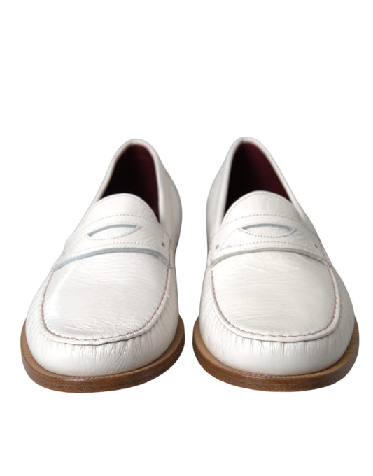 Pair of white leather shoes with brown soles