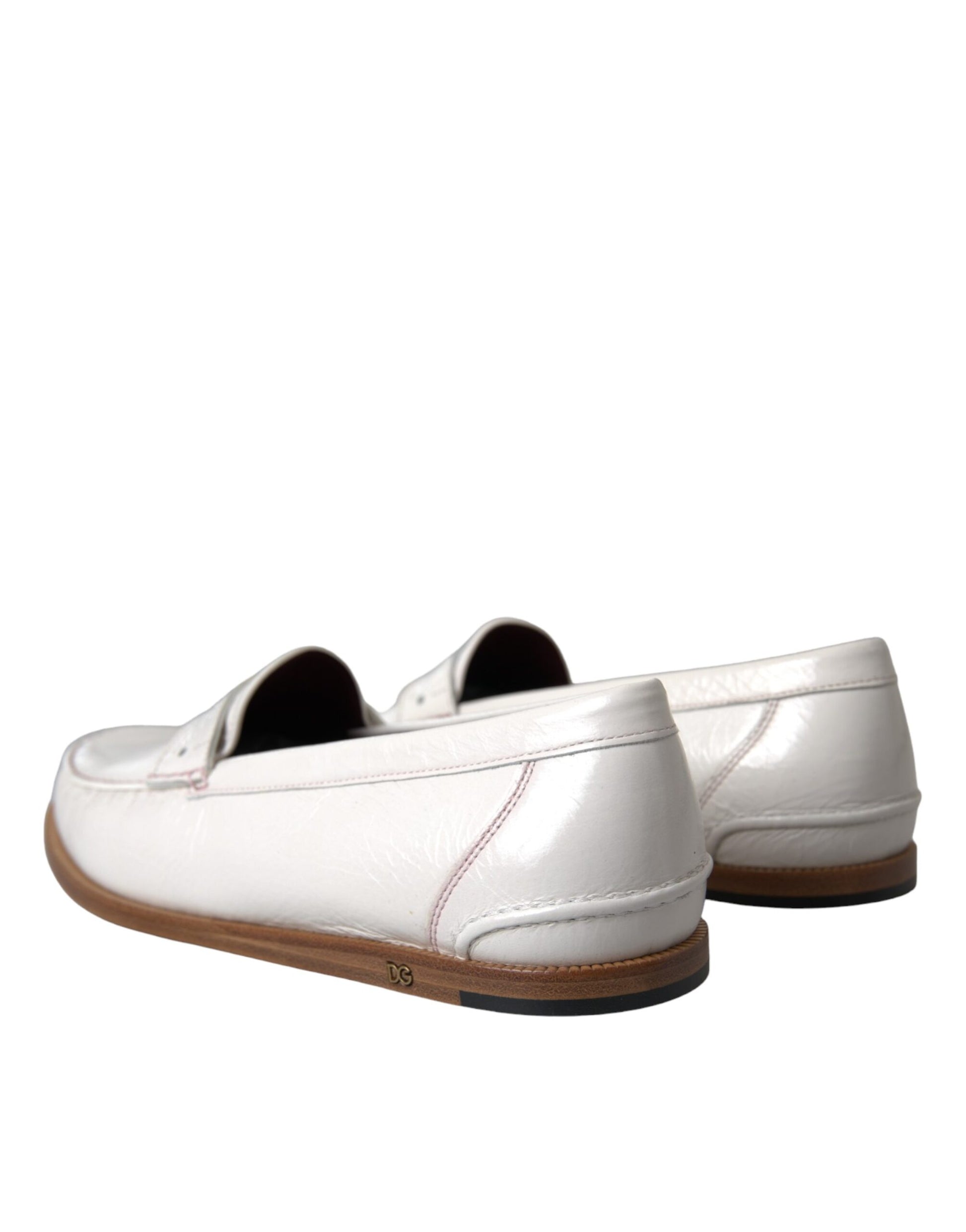 Pair of white shoes with brown soles