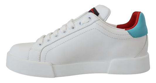 A white leather sneaker with a red and blue heart logo on the side