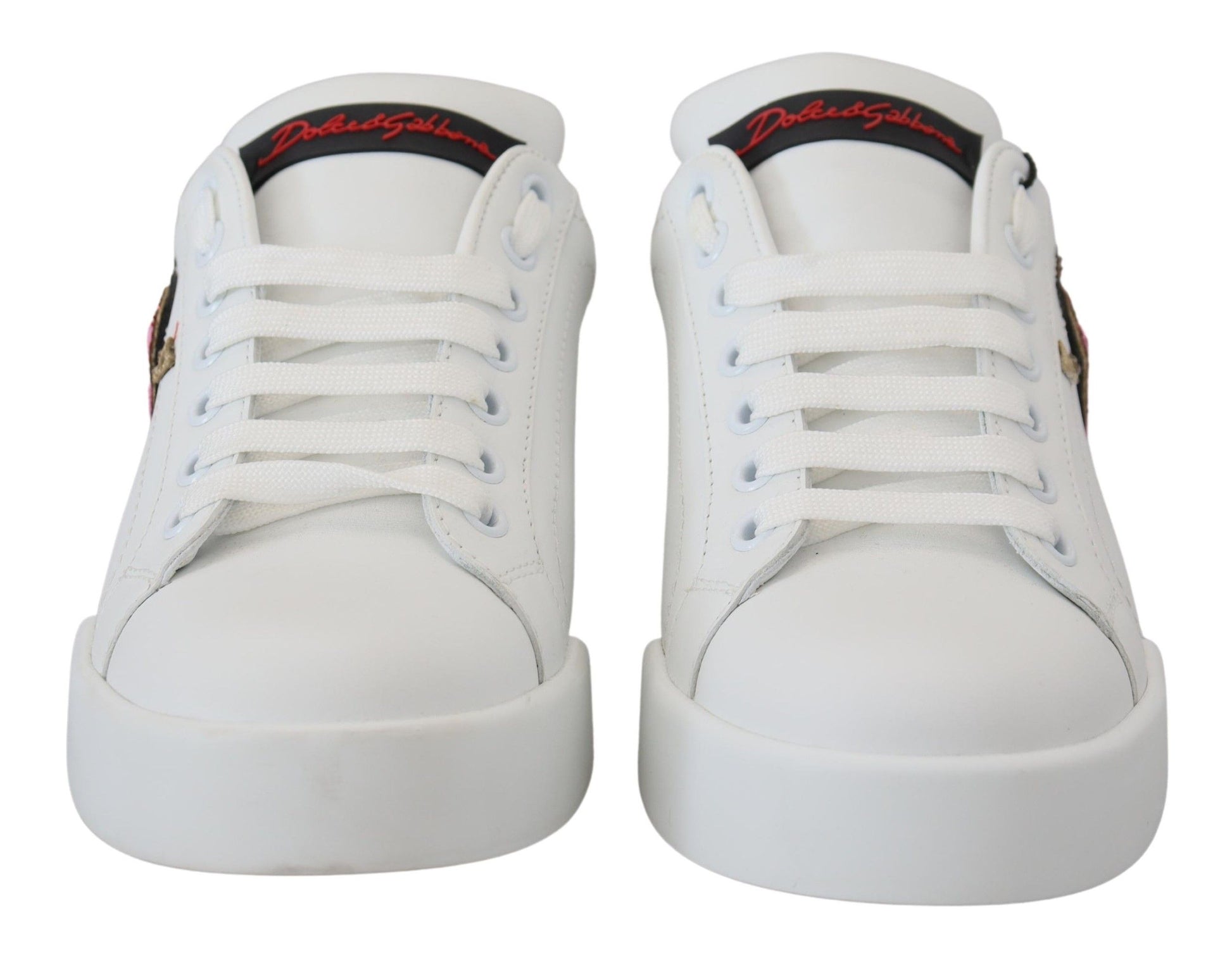 White leather sneakers with red heart logo on side and black laces