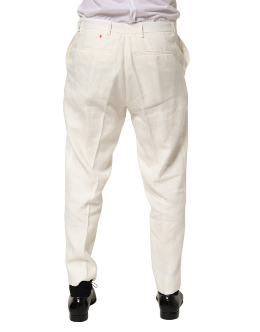 A pair of men's trousers in a light beige color. They appear to be made from linen and have a relaxed fit wit