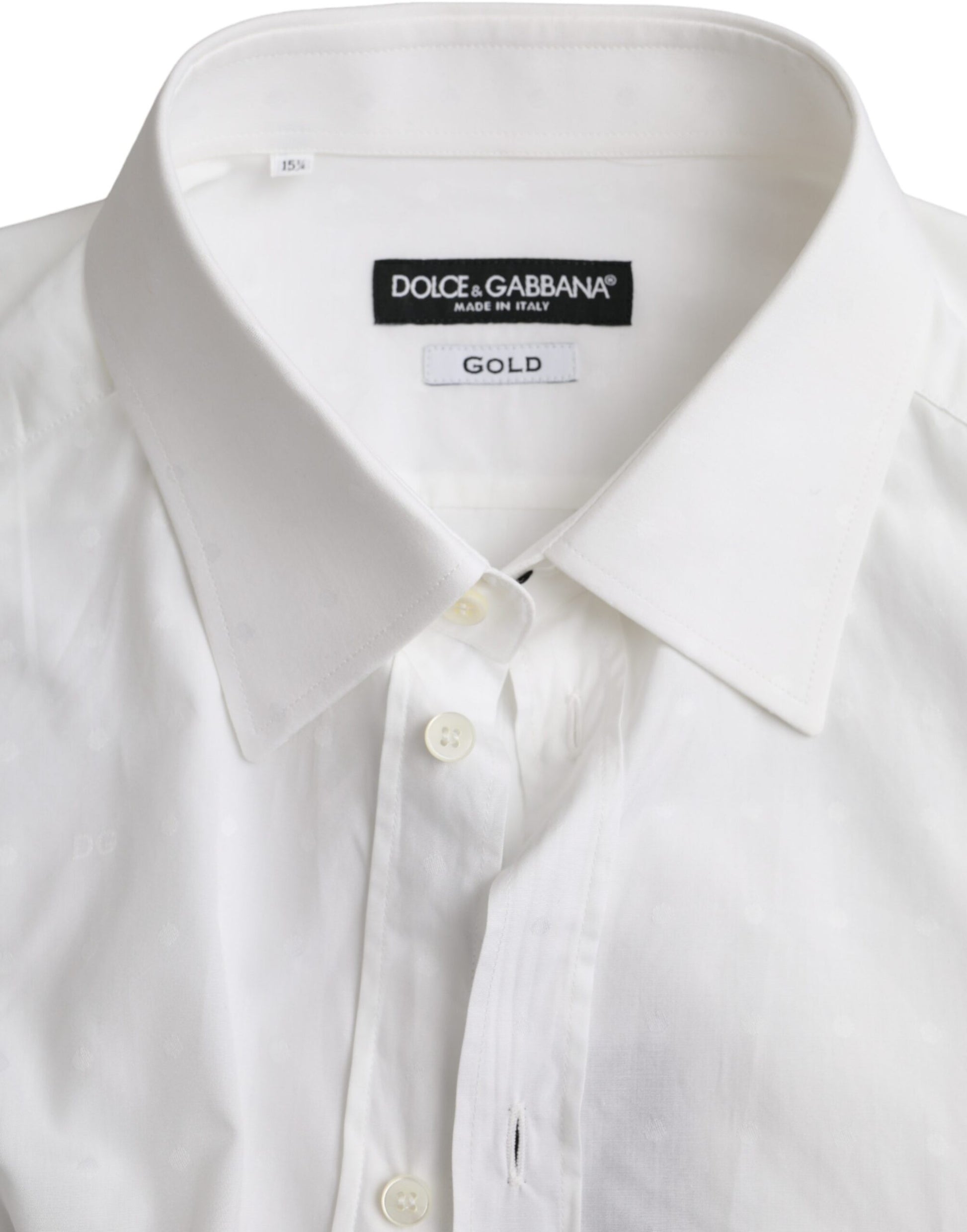 A white dress shirt with a gold logo on the left chest area, designed by Dolce & Gabbana