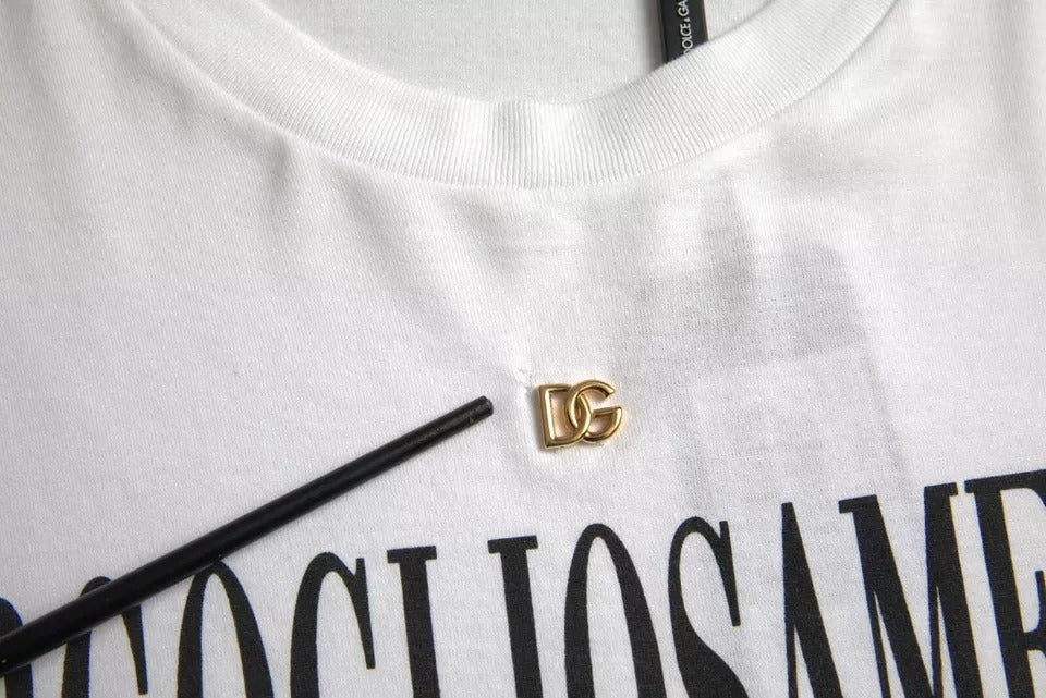 White t-shirt with black lettering and a gold button