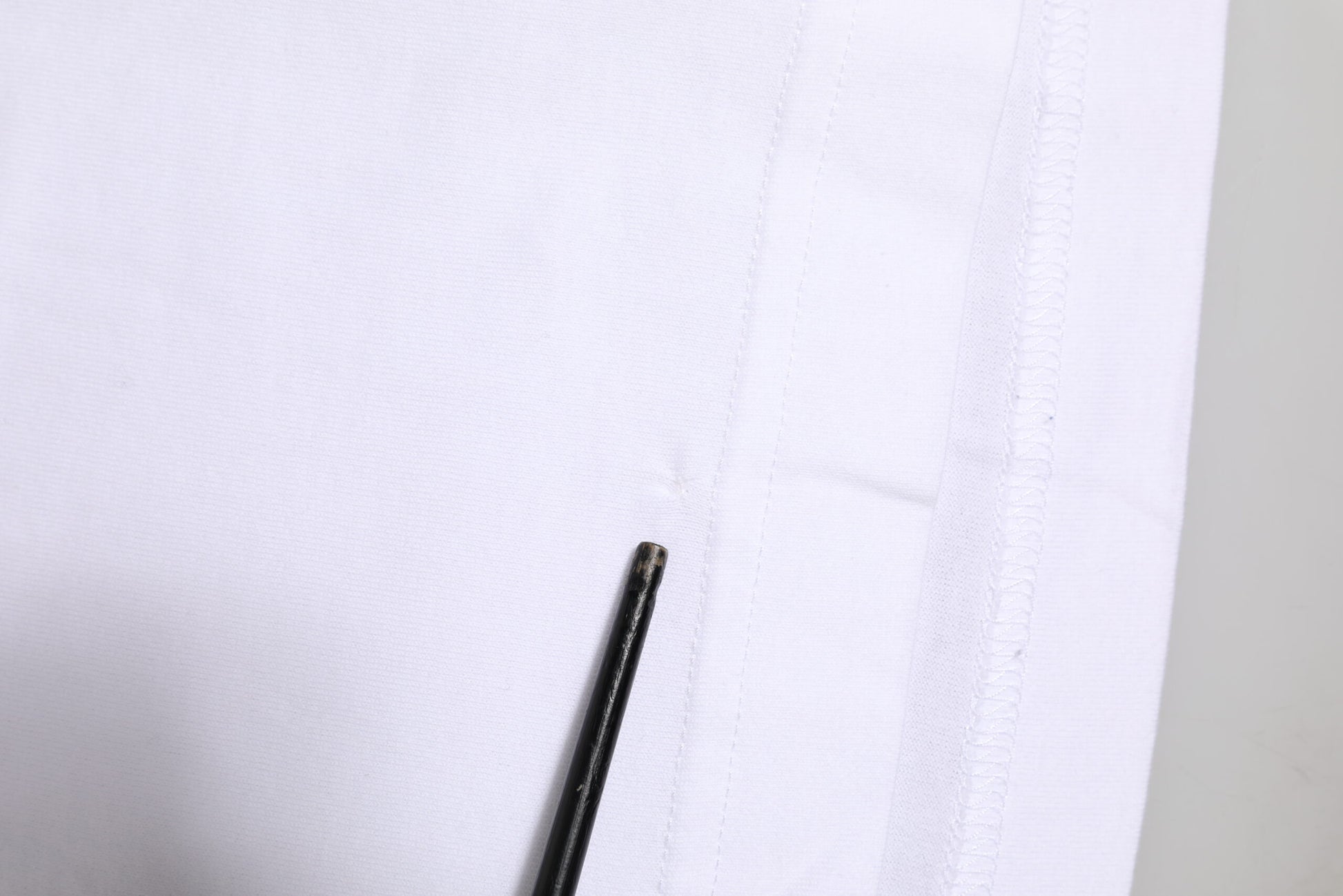 Black object on white fabric