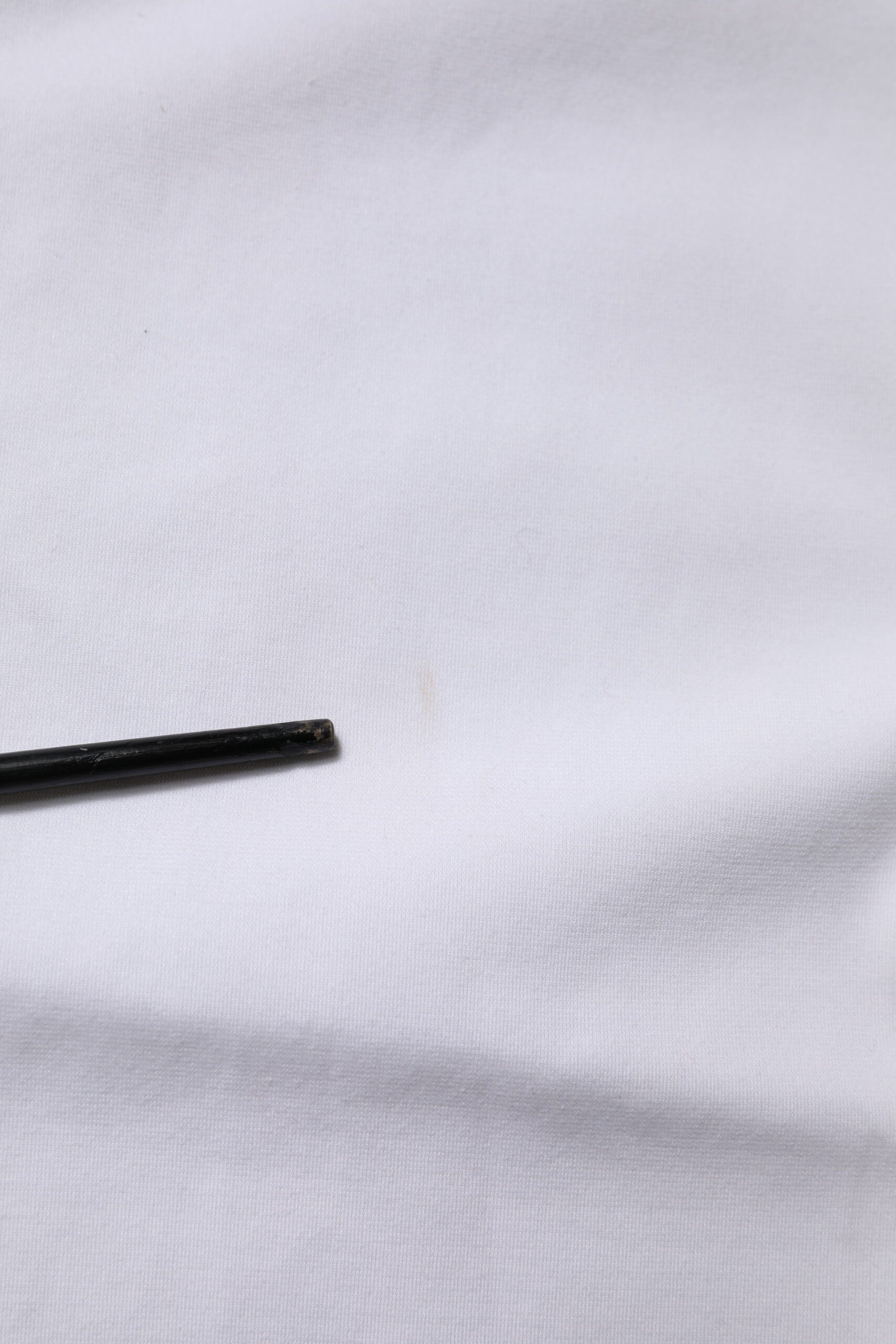 Black object on white fabric
