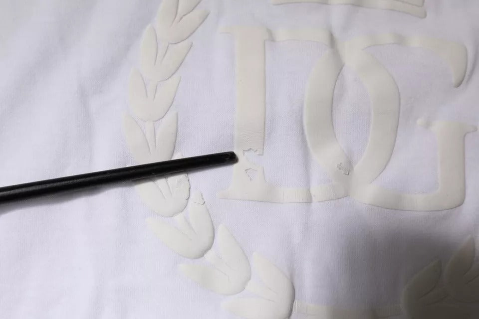 Black pen on white fabric with embroidered logo