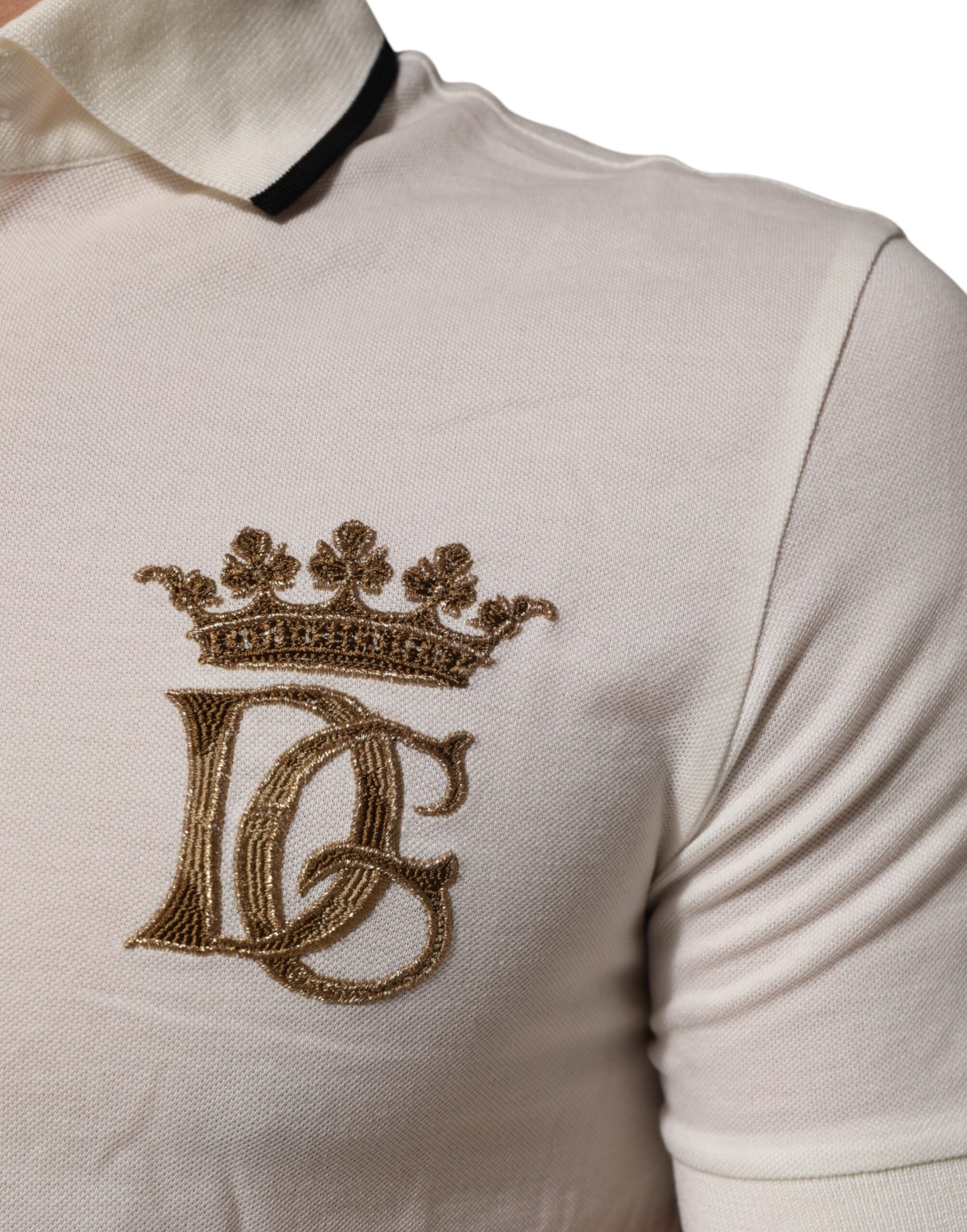 White polo shirt with gold crown logo on left chest