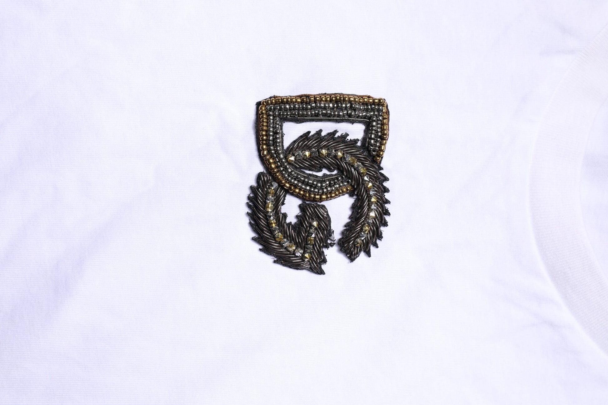 Small embroidered emblem on fabric