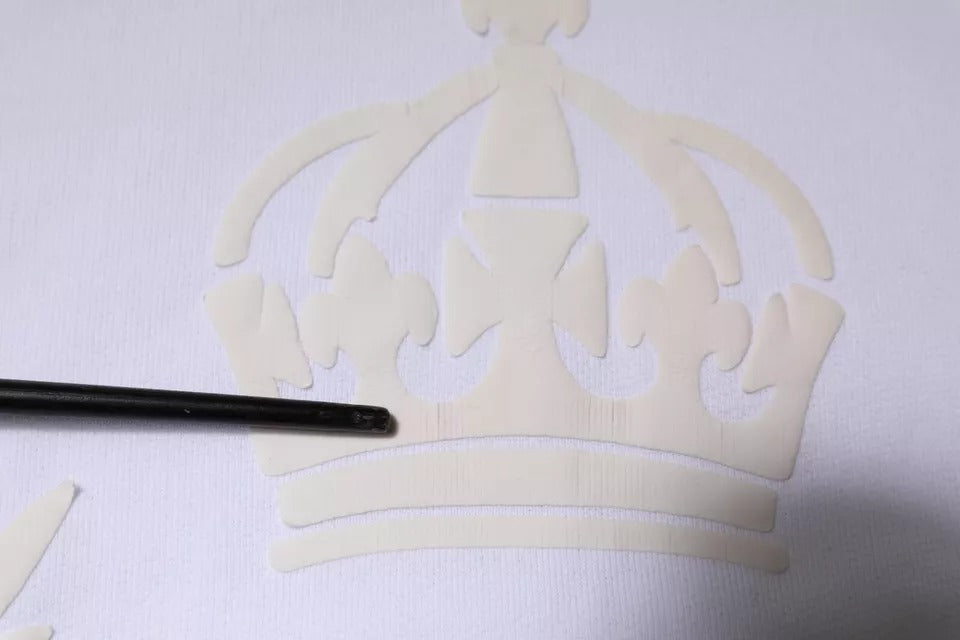 Crown shaped cookie cutter on white fabric