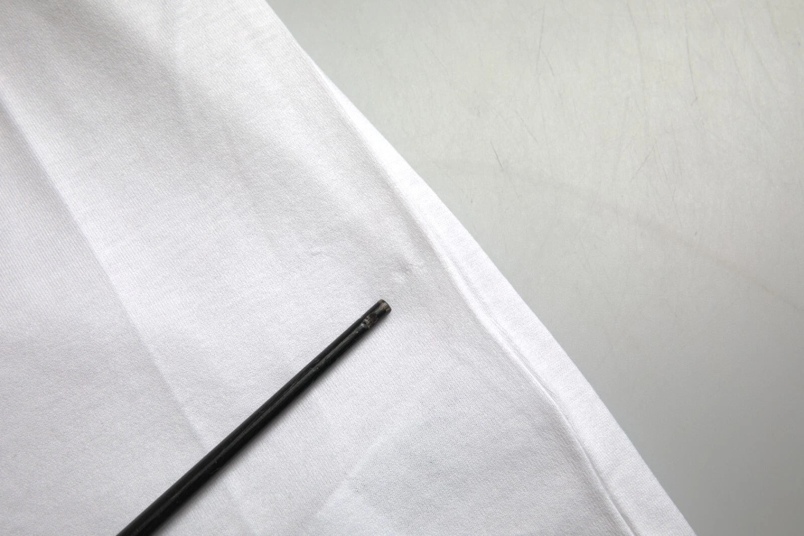 Black pen on white fabric