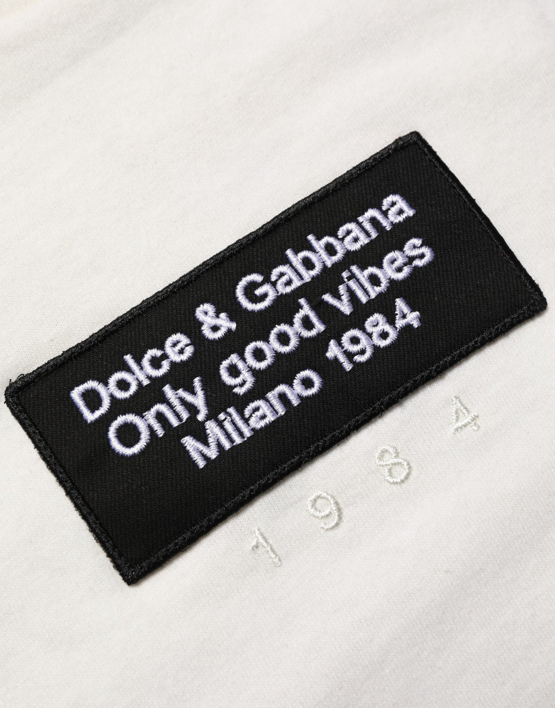 Black patch on white fabric with embroidered text