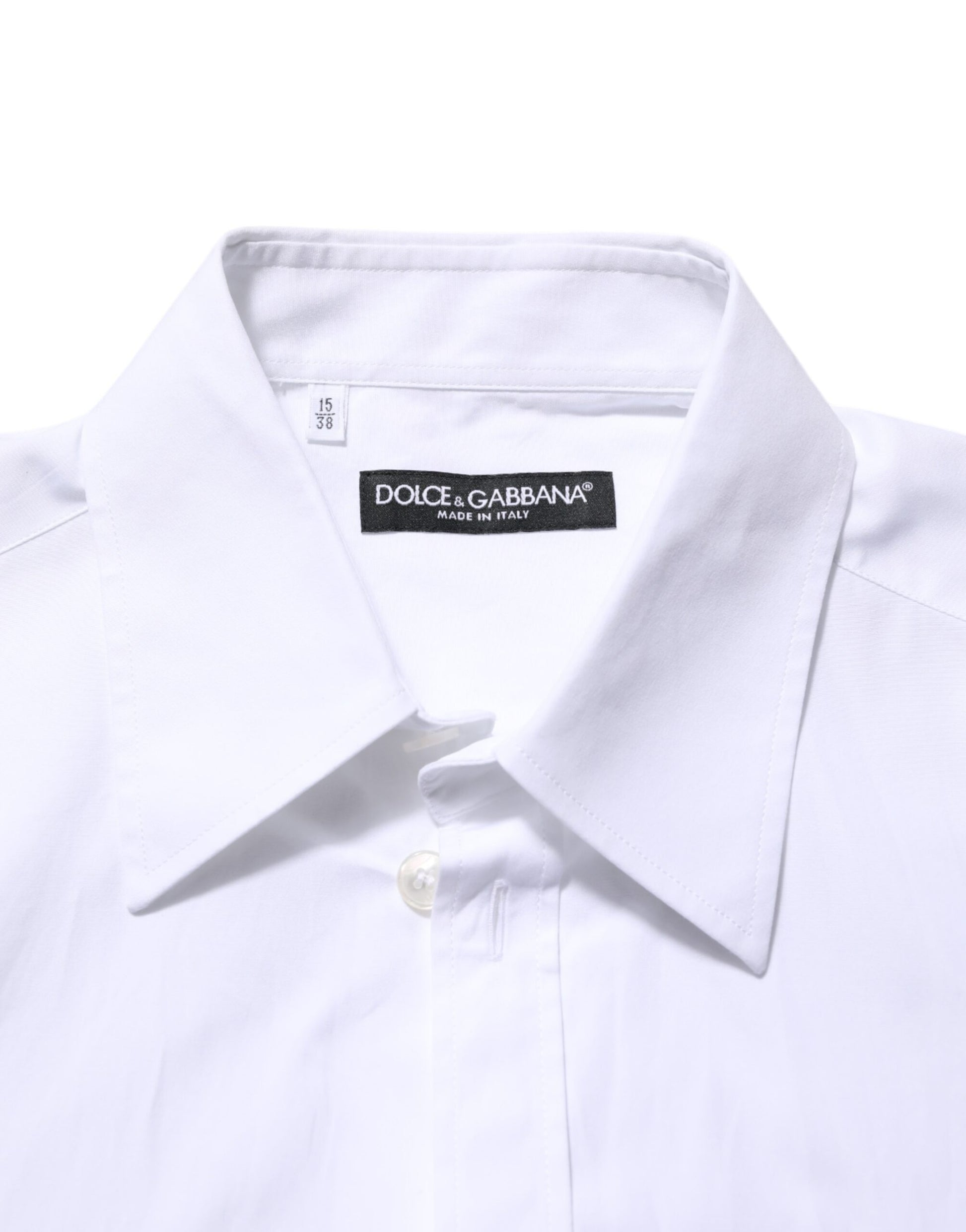A white collared shirt with a logo plaque on the chest