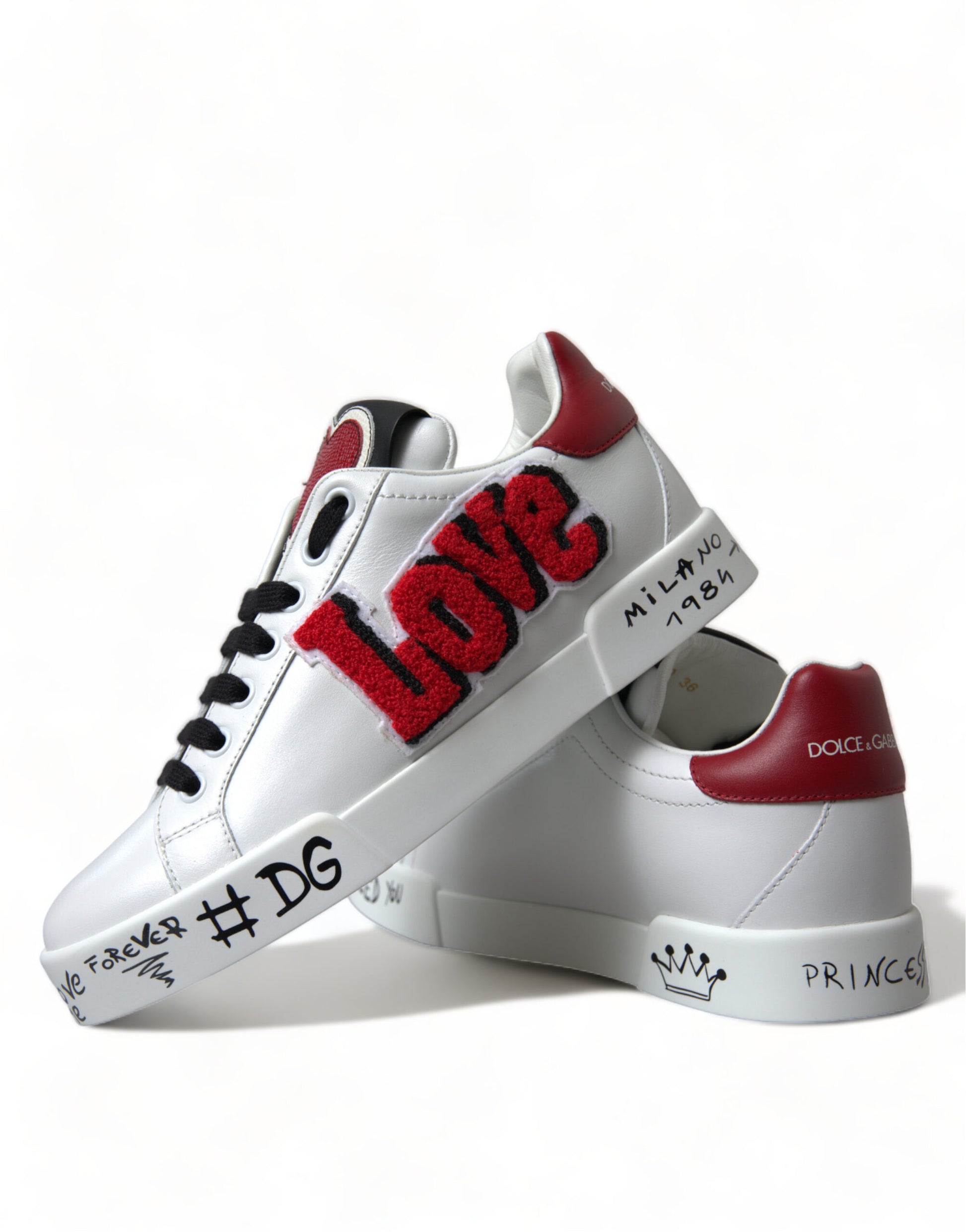 Pair of white sneakers with red accents and LOVE written on side in large letters