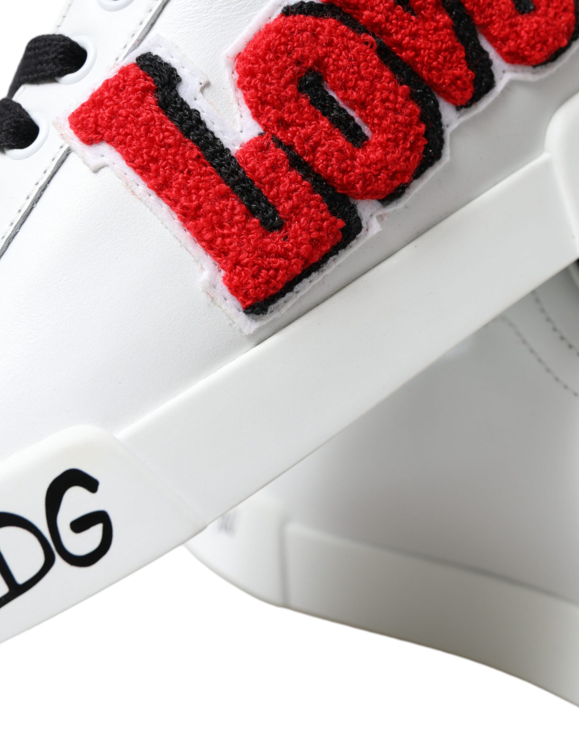 White sneaker with red and black lettering spelling LOVE