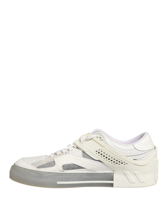 A pair of white low top sneakers with a custom design by Dolce & Gabbana, featuring the brand's logo on the side and a unique