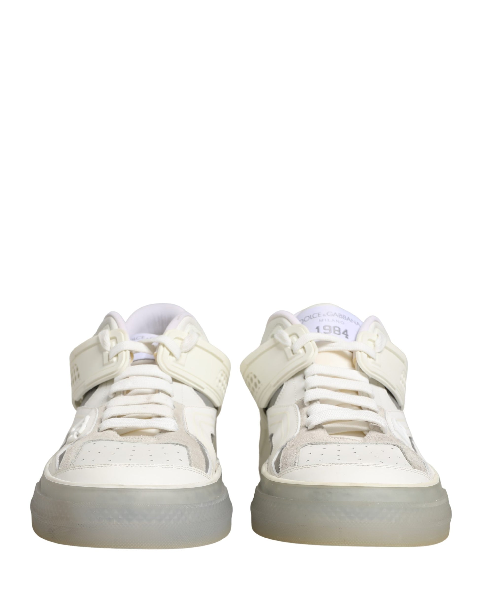 Pair of white sneakers with laces and a low top, featuring the brand's logo on the side