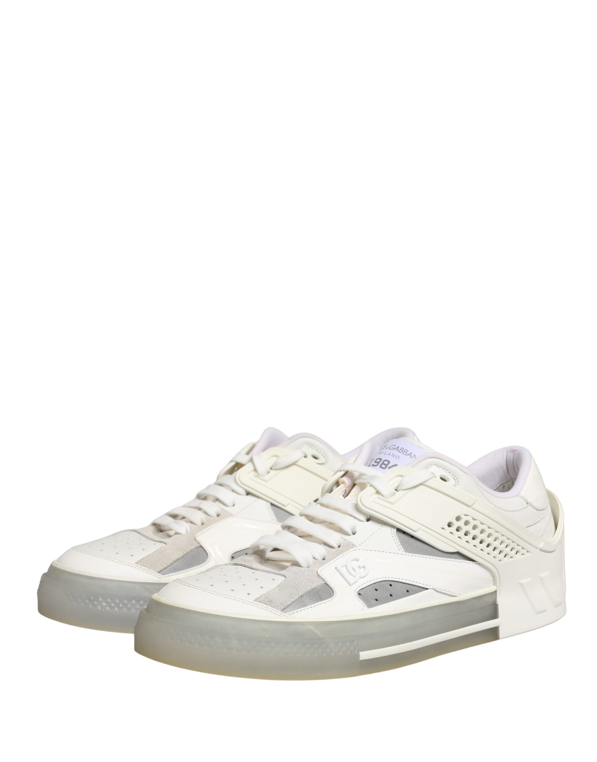 Pair of white low top sneakers with black laces and logo on side