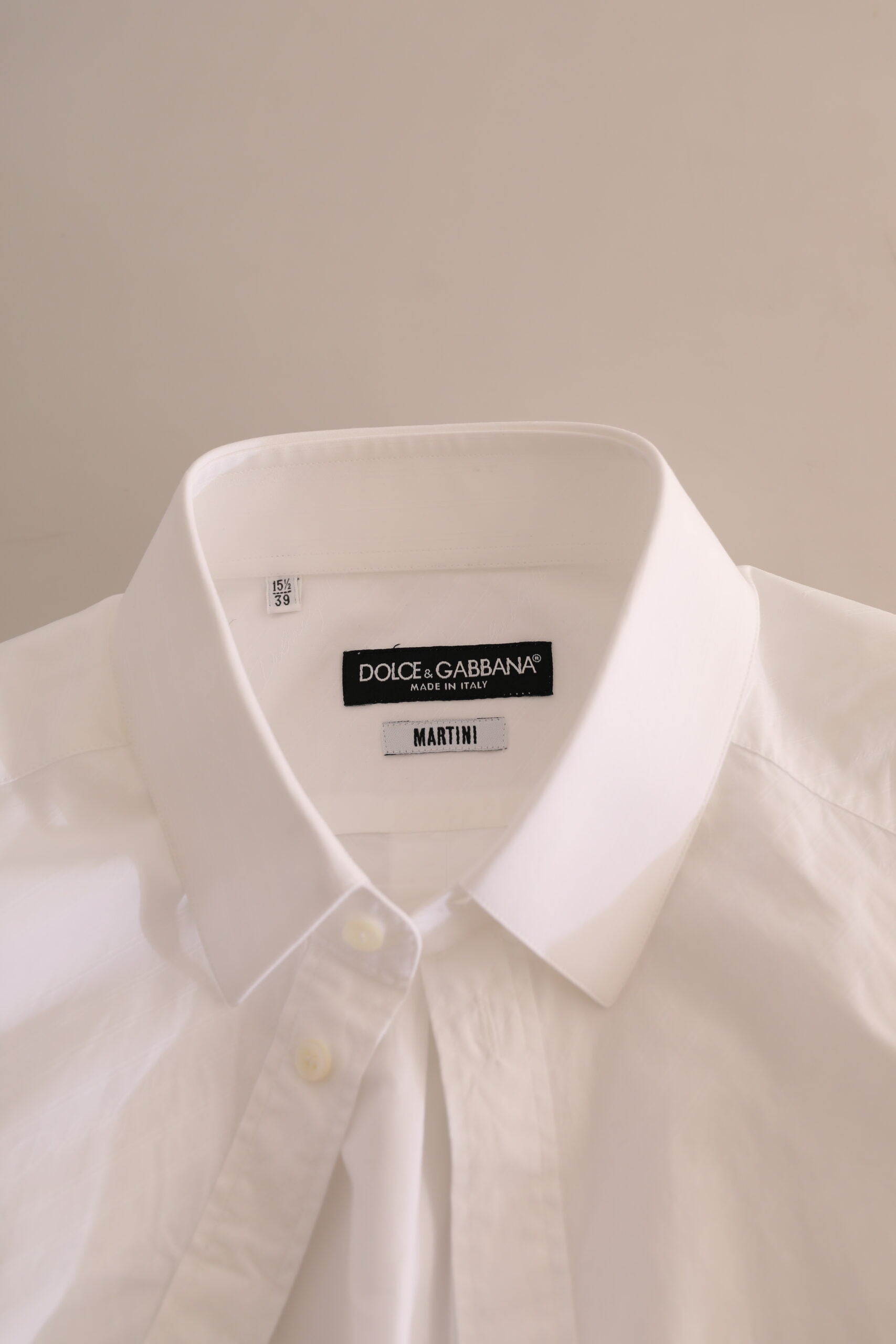 A white dress shirt from Dolce & Gabbana, with a black label that reads "D&G MARTINI"