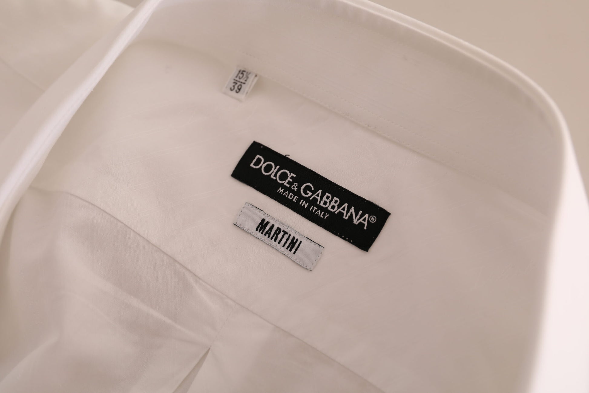 A white dress shirt with a black label that reads "Dolce & Gabbana Martin" visible on the front