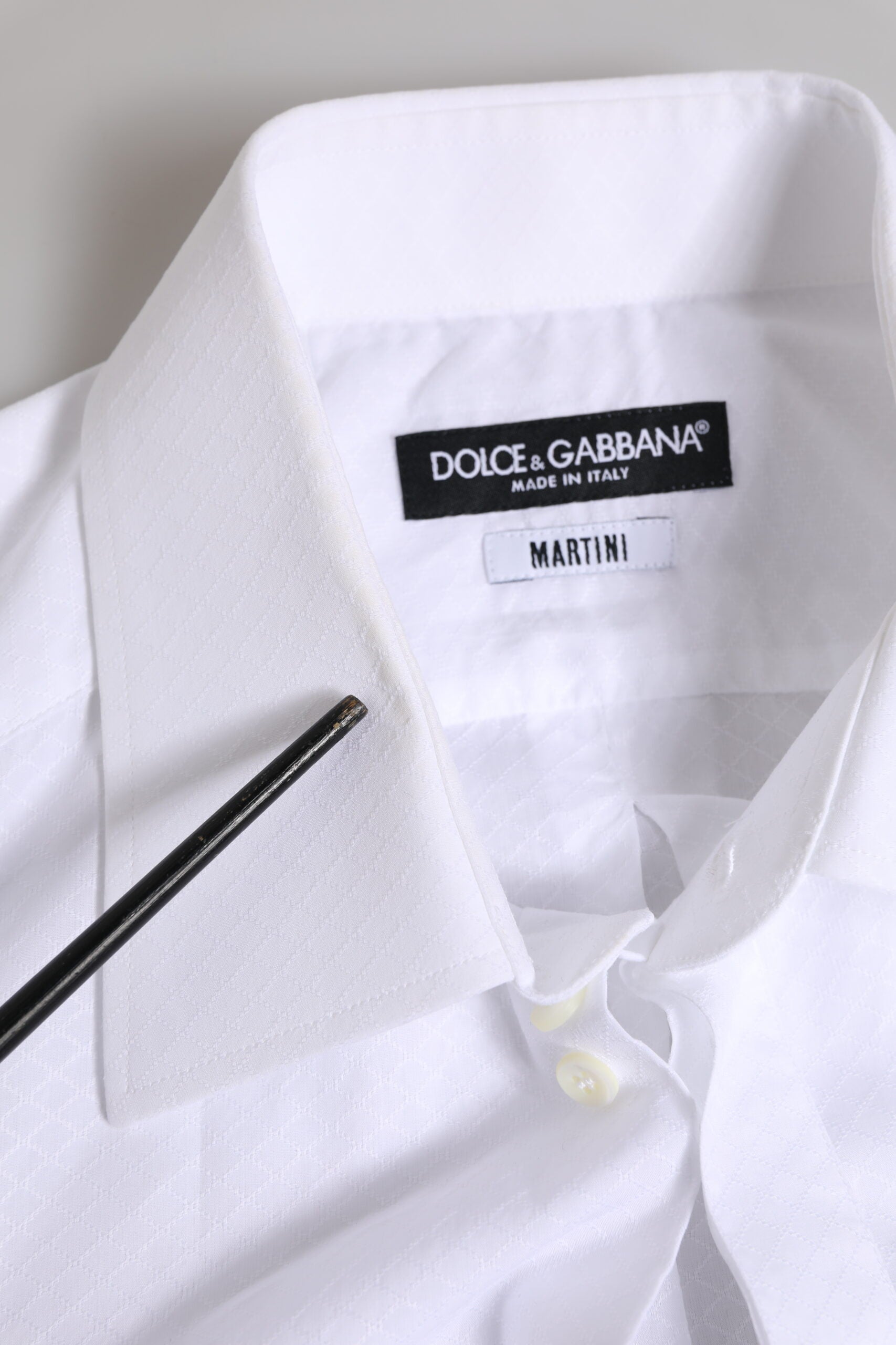 A white dress shirt with a black label that reads "Dolce & Gabbana Martin