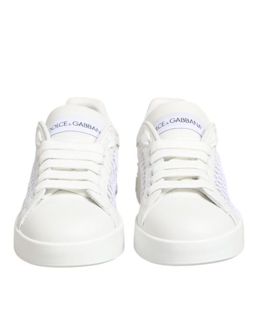 Pair of white sneakers with laces and a logo on the side