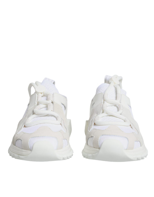 Pair of white mesh sneakers with laces and a pull tab on the back