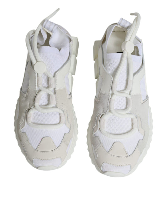 Pair of white mesh sneakers with laces and straps, featuring a chunky sole design