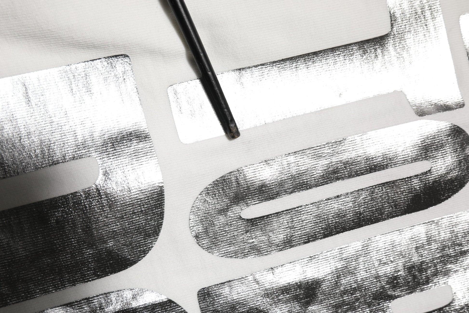 Silver foil lettering on fabric