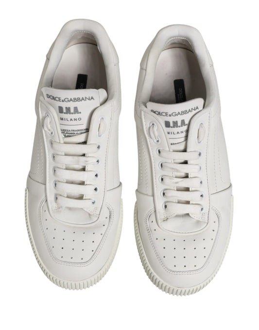 Pair of white sneakers with black laces and logo on side