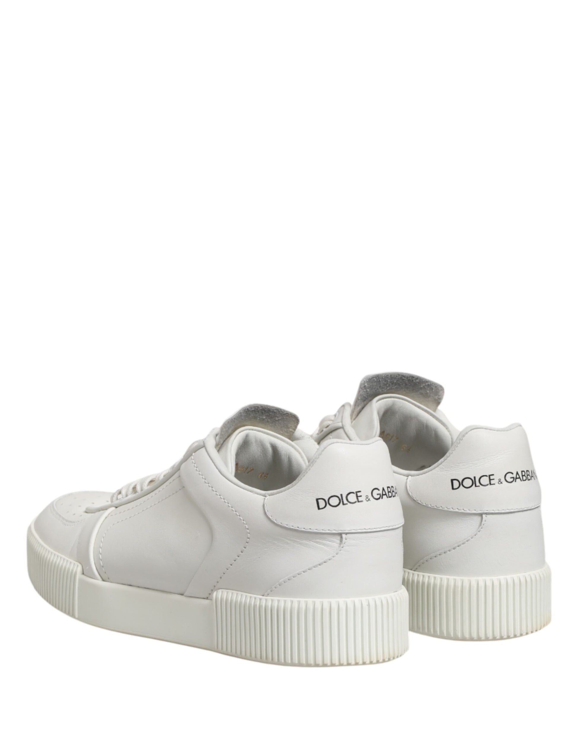 A pair of white sneakers with a low top, featuring the brand name "Dolce & Gabbana" on the side