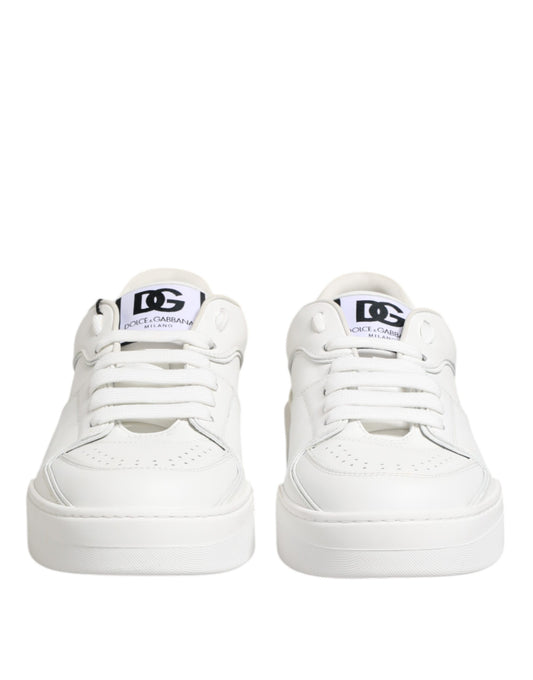 White leather low top sneakers with black laces and logo tag on tongue
