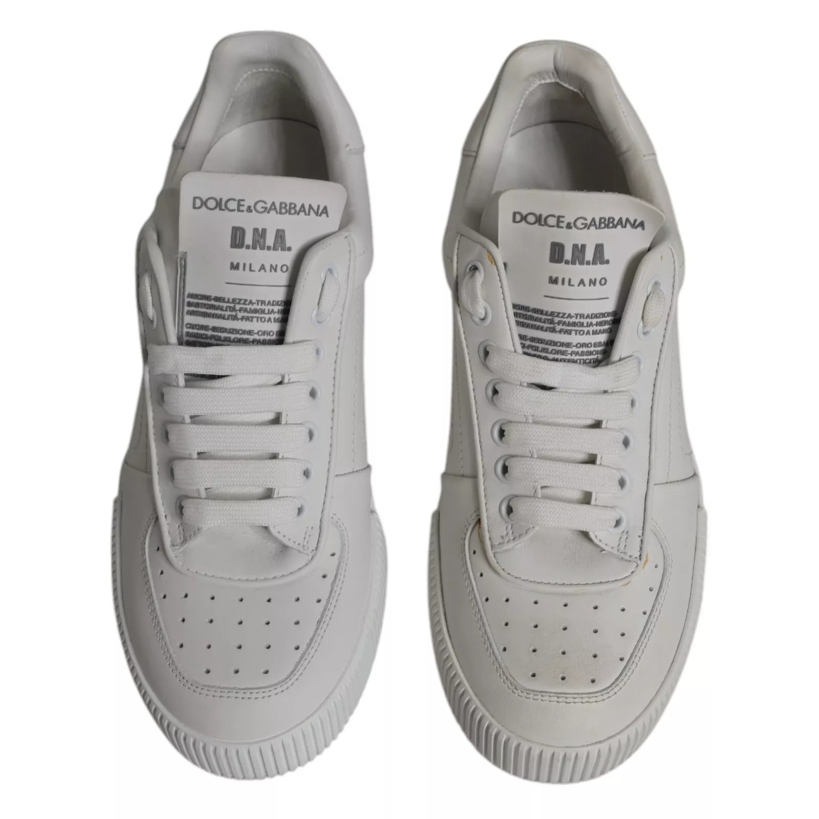 White sneakers with black logo on side