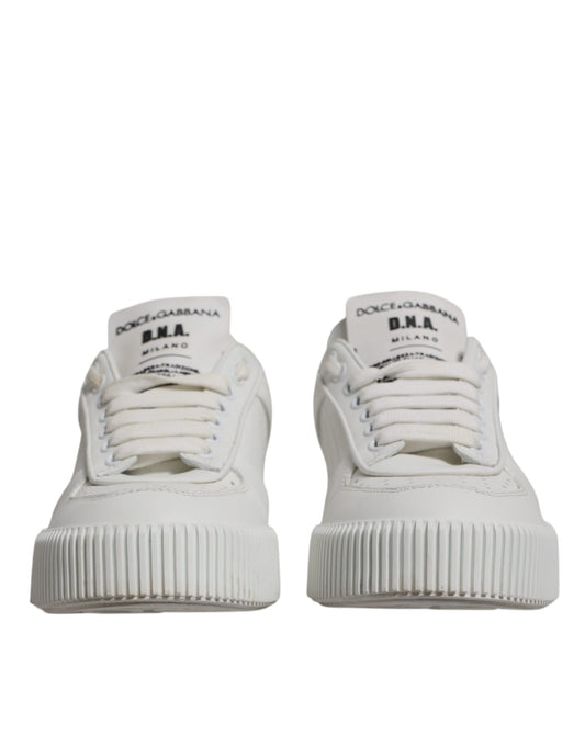 Pair of white sneakers with black laces and soles