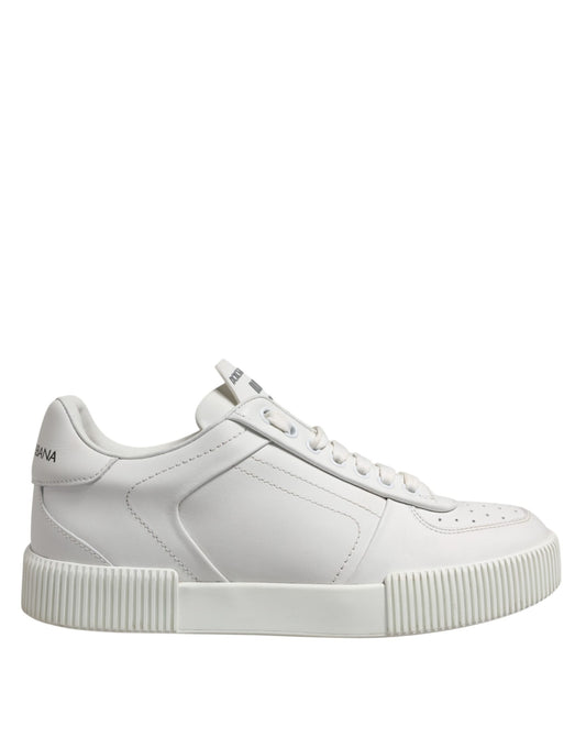 White leather low top sneakers with chunky sole and laces, featuring a logo on the side