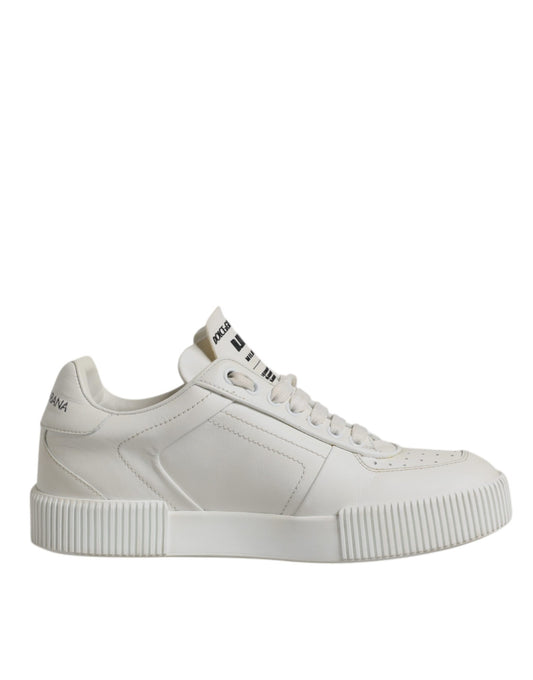 A pair of white leather sneakers with a low top, featuring a chunky sole and a logo on the side