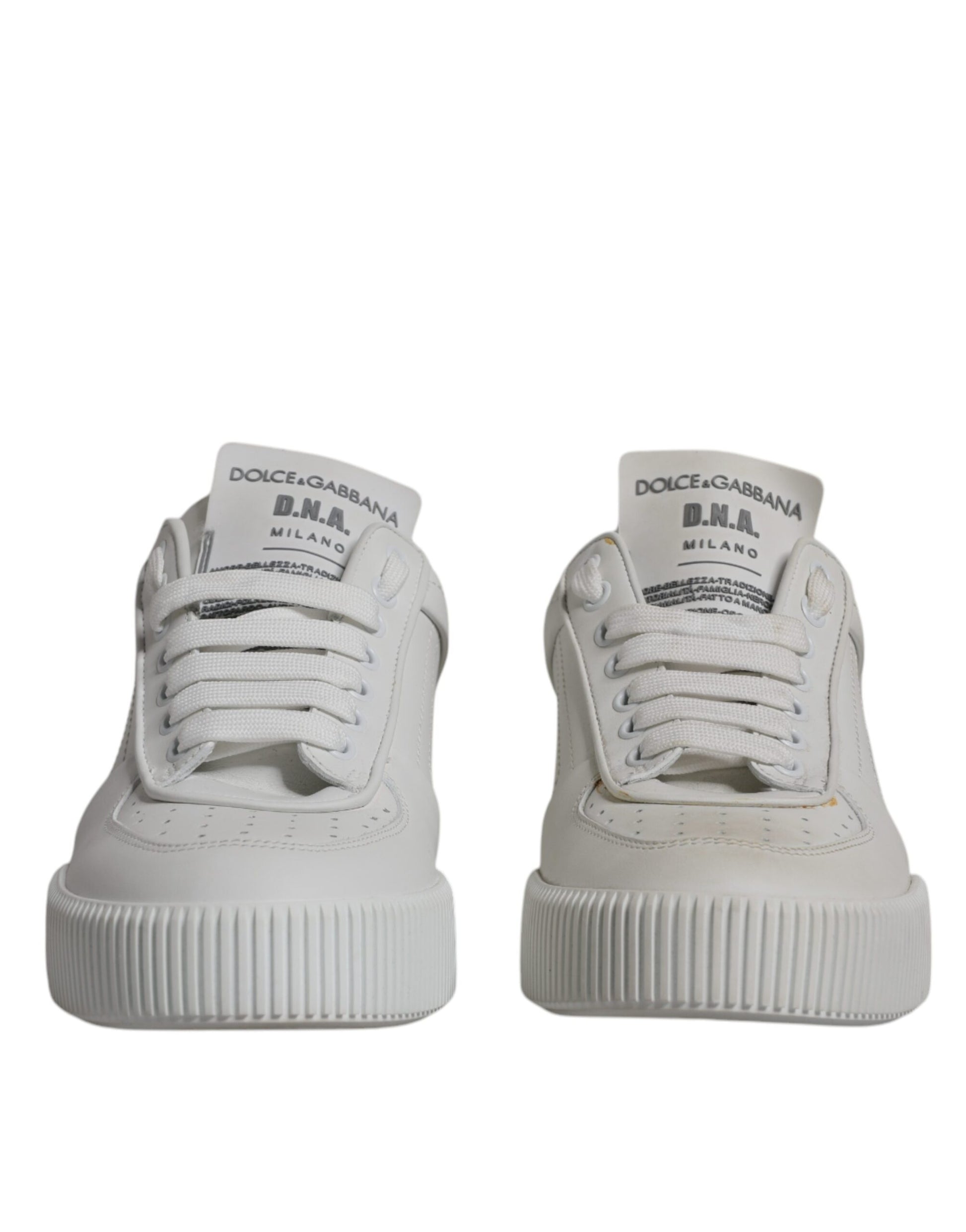 Pair of white leather sneakers with low top and textured sole, featuring brand logo on side