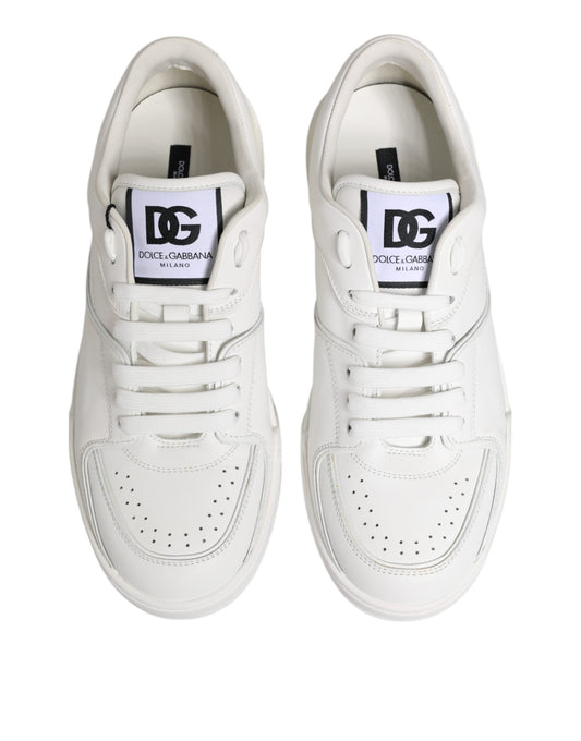 Pair of white leather sneakers with black laces and logo tag on tongue