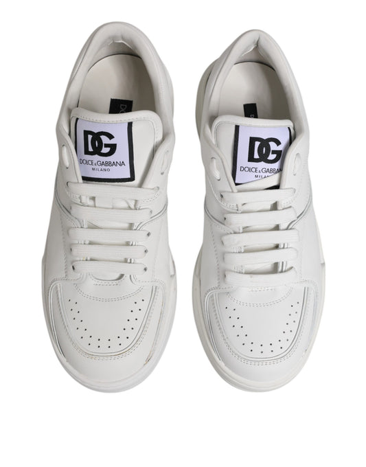 Pair of white leather sneakers with black laces and logo on side