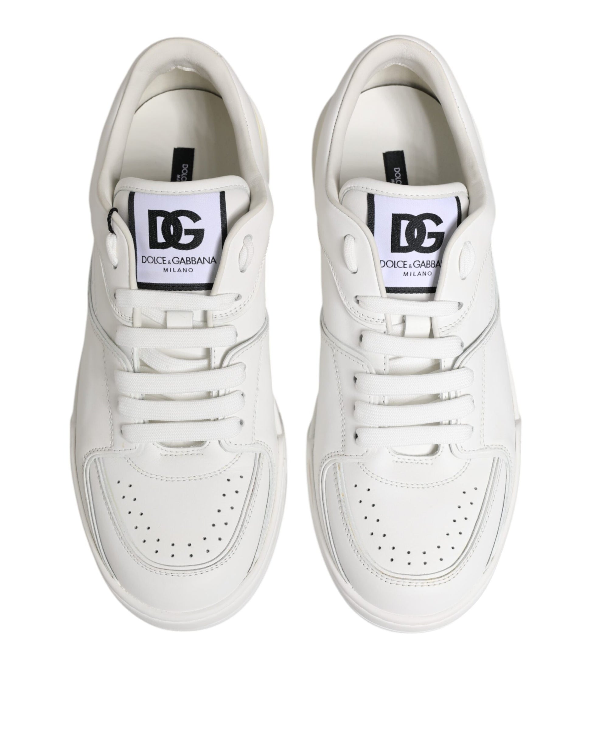 Pair of white leather sneakers with black laces and logo tag on tongue