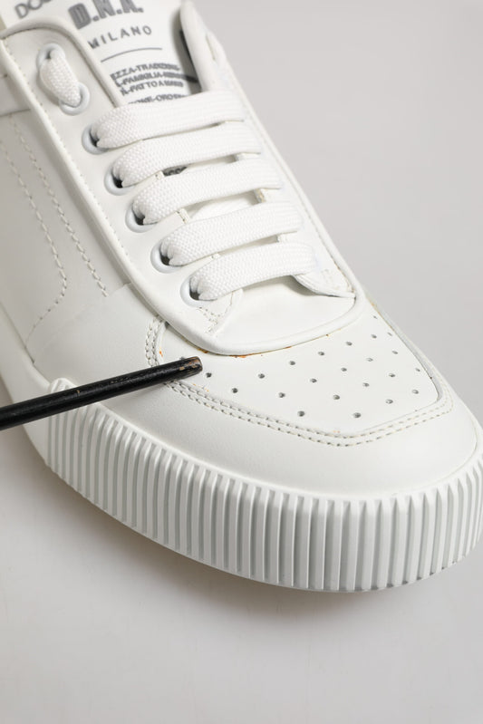 White leather sneakers with black laces, low top, and rubber sole