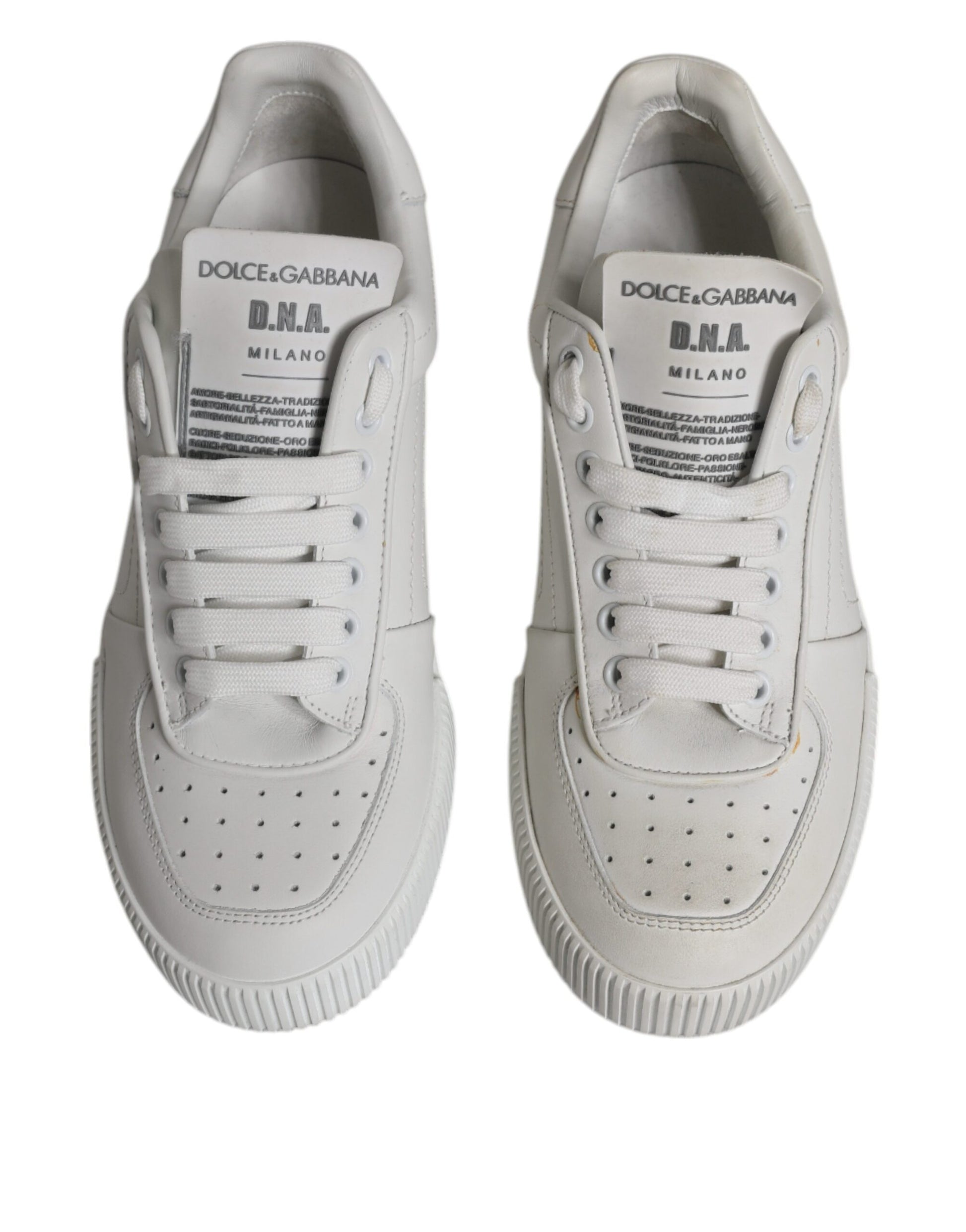 Pair of white leather sneakers with black laces and logo, featuring a low top design
