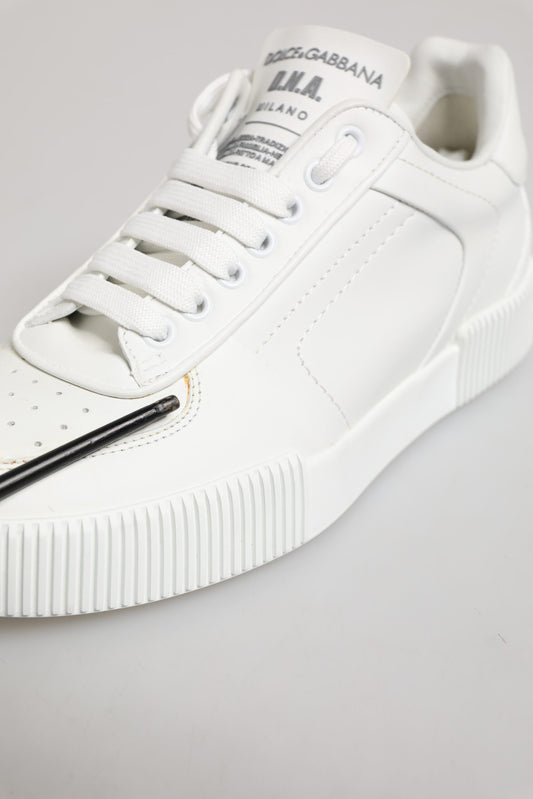 White leather sneakers with low top, laces, and side stripe detailing