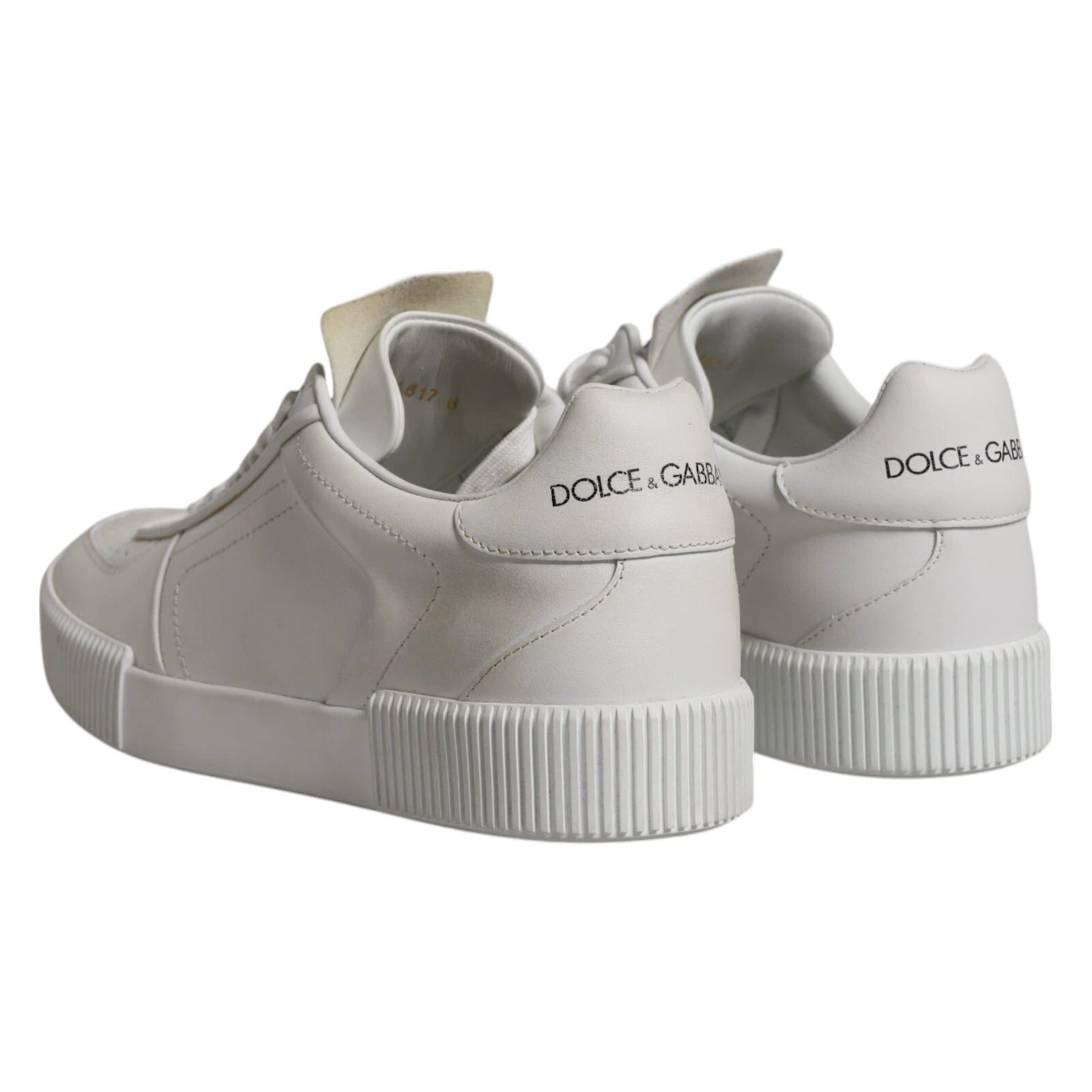 Pair of white sneakers with a logo on the side