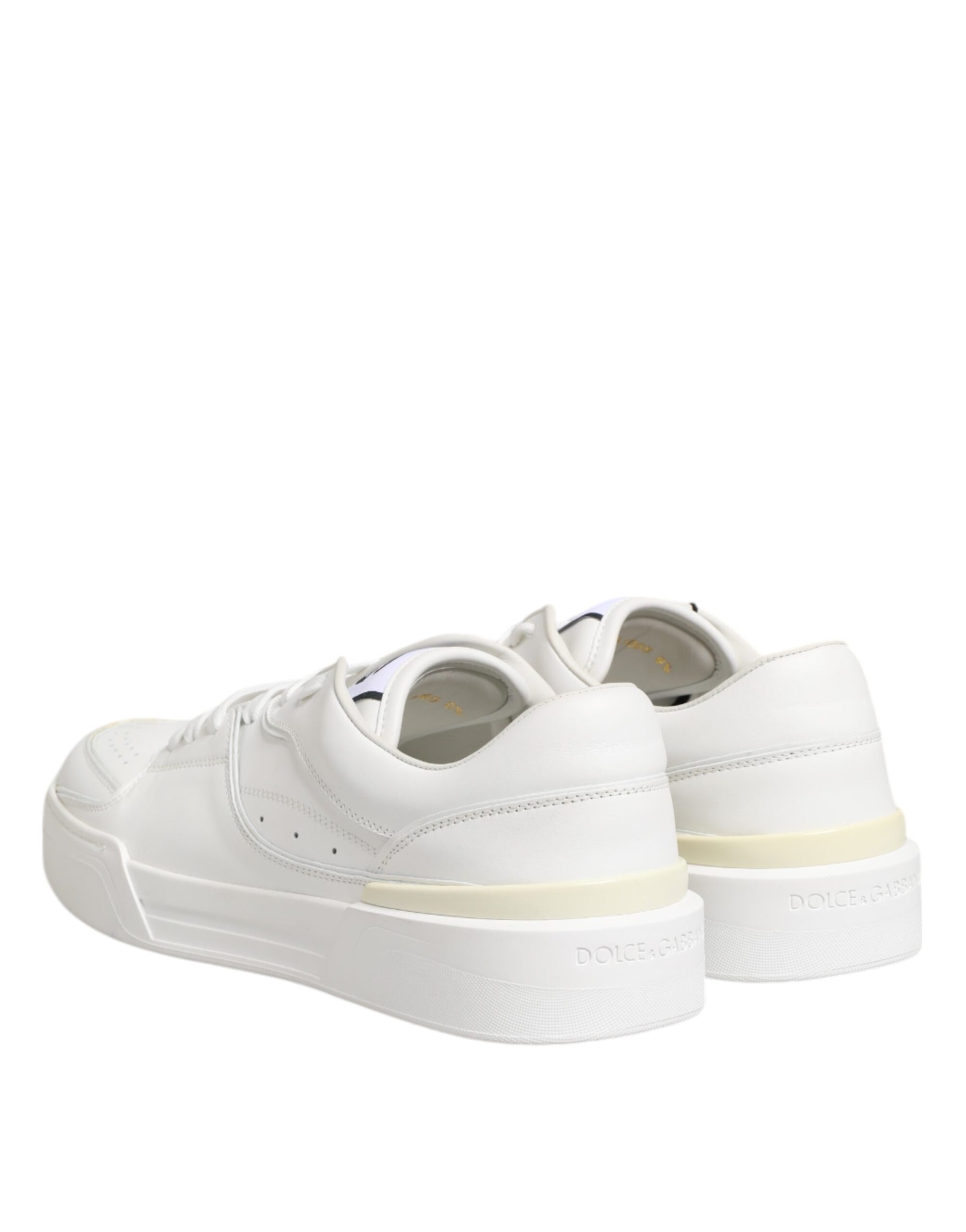 Pair of white leather sneakers with low top, laces, and logo on side