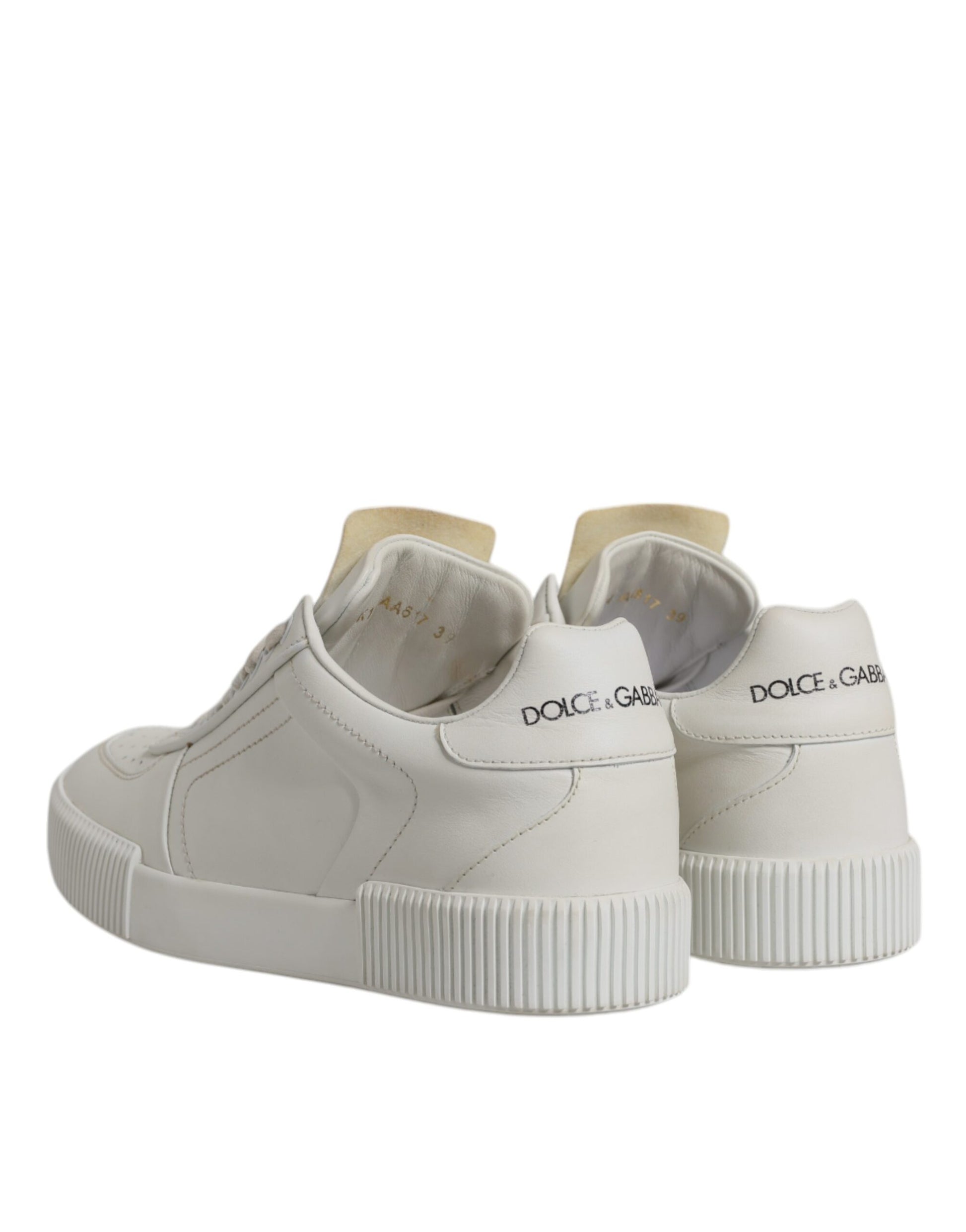 Pair of white leather sneakers with low top, featuring a chunky sole and brand logo on side