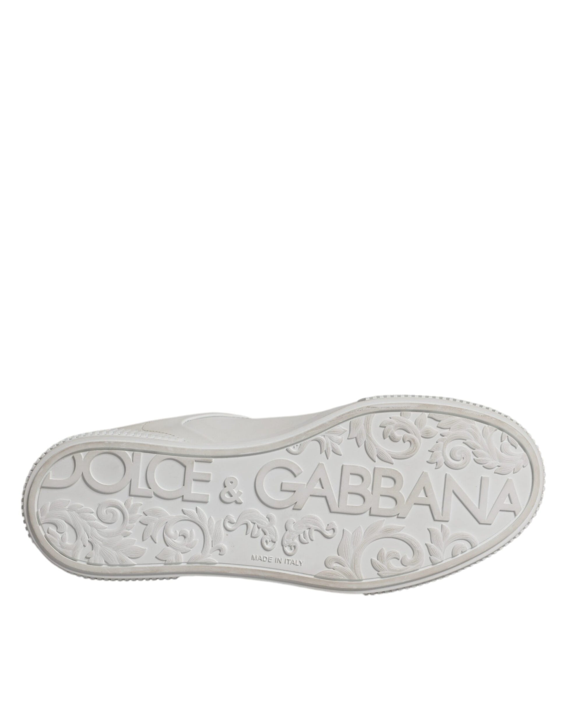 Silver shoe with white sole, featuring brand name "Dolce & Gabbana" in embossed letters