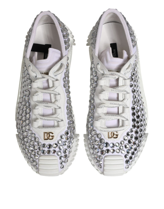 Pair of white sneakers with embellishments and gold accents