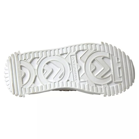 A pair of white canvas leather sneakers with embellishments, featuring the Dolce & Gabbana logo